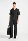 pierre-relaxed-fit-pleated-tailored-trousers-black