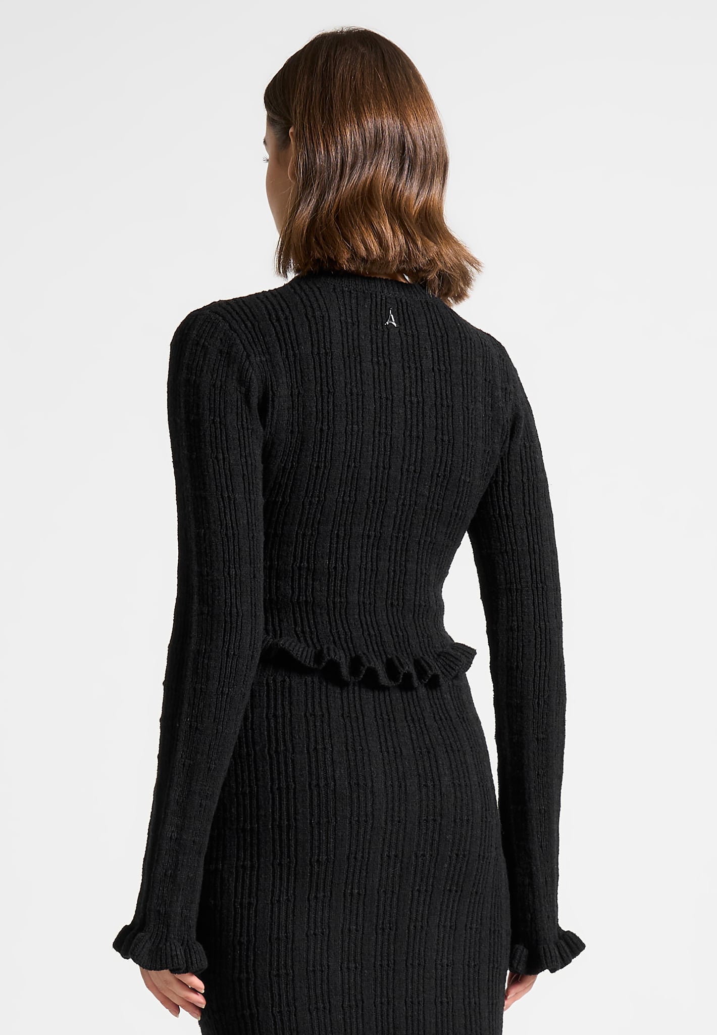 ruffle-hem-ribbed-knit-top-black