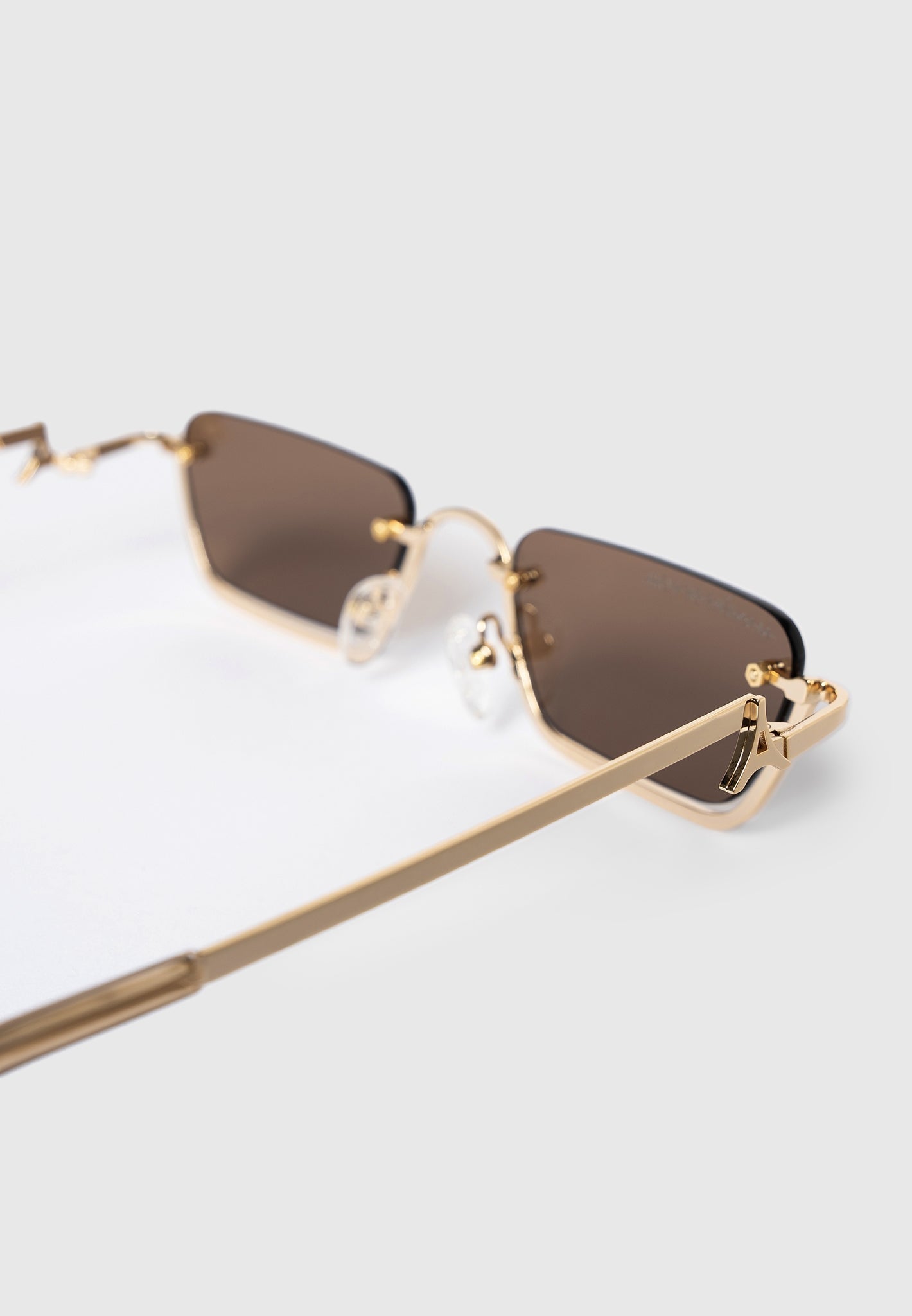 sacha-rectangular-frameless-sunglasses-gold