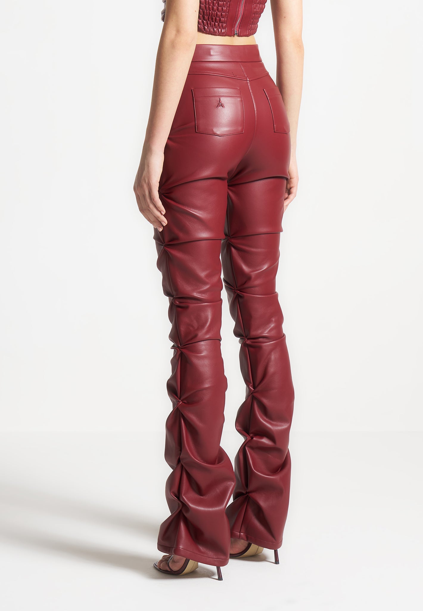 tacked-vegan-leather-flared-trousers-wine-red