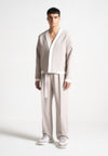 relaxed-fit-textured-belted-tailored-trousers-stone
